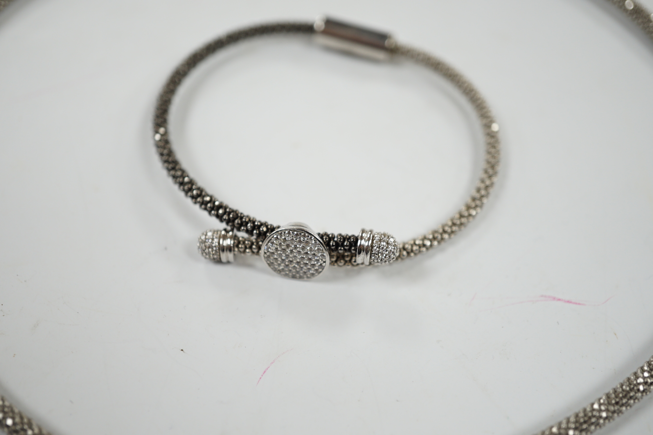 A modern Links of London, silver necklace with diamond cluster motif and a similar bracelet, in Links of London box.